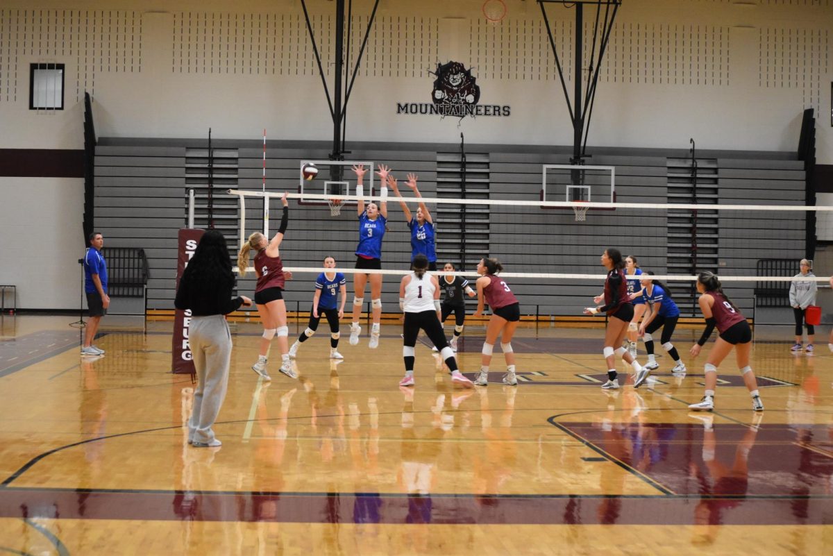 Emily Bozena, '25, attempting a kill during a game against Pleasant Valley