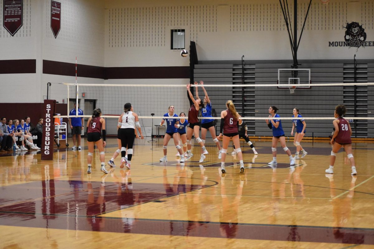 Olivia Full, '26 sets the ball to her teammate in an attempt to get a kill.