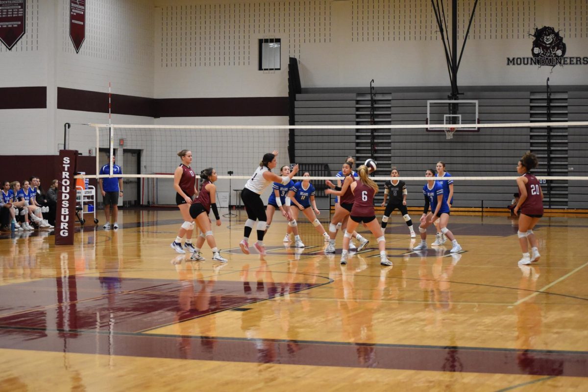 Emily Bozena, '25 passes the ball to setter, Olivia Full, '26.