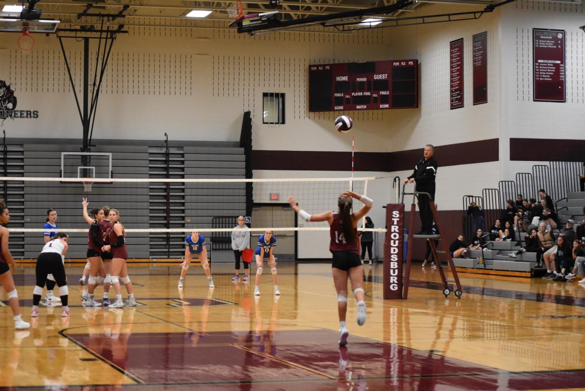 Melanie Barbaran, '26 serves in a game against Pleasant Valley.