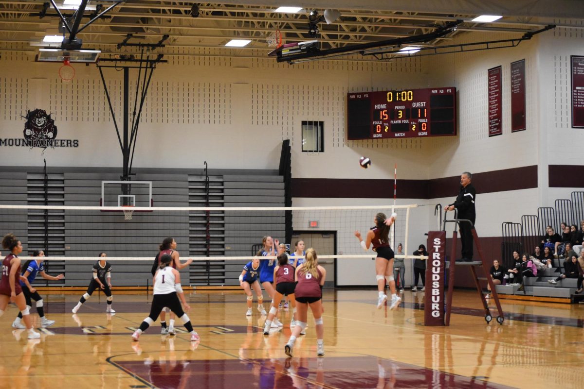 Melanie Barbaran '26 going up for the kill against Pleasant Valley