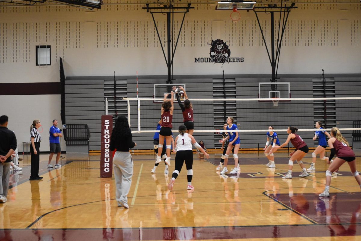 Madelyn Vargas '27 and Cotoria McCarthy '26 going up for the block 