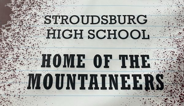 The "Home of the Mountaineers" banner hanging in the lobby of the high school