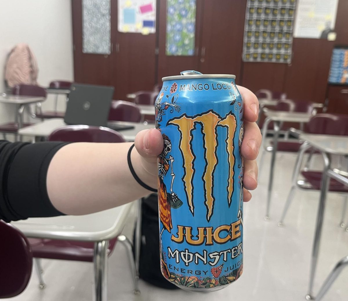 Rebecca Dishong holds up her Monster drink which she drinks while doing her schoolwork.