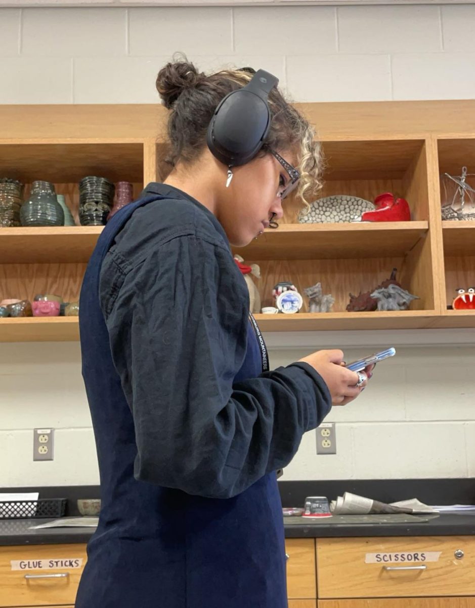 SHS student staring at her phone while she has free time in class. 