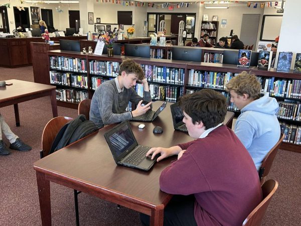 Chess players Jacob Bajek, '25, Jacob Patcher, '27, and Mason Ulmer, '27, sitting at a table prior to their matchup against Pocono Mountain West on November 12.