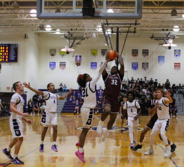 Center, Mehki Kirkland, '25 drives the ball forward for a jump shot against East Stroudsburg North. 