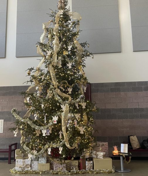 The seniors winning "memorial tree" standing tall and proud featuring golden decorations