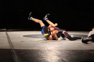 Albert Bialasiewicz, '26, taking down his opponent during his match.