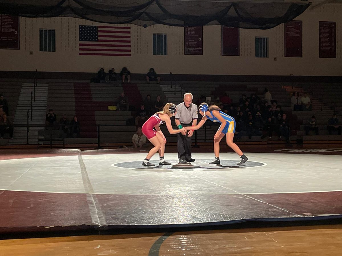 Cheyenne Altemose, '27, shaking hands against her opponent before their match begins.