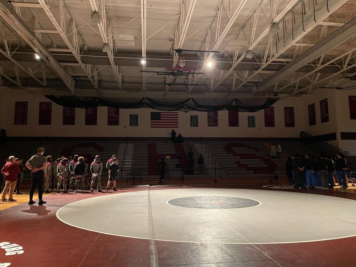 Both SHS Wrestling teams and William Allen High School pledging allegiance to the American flag.