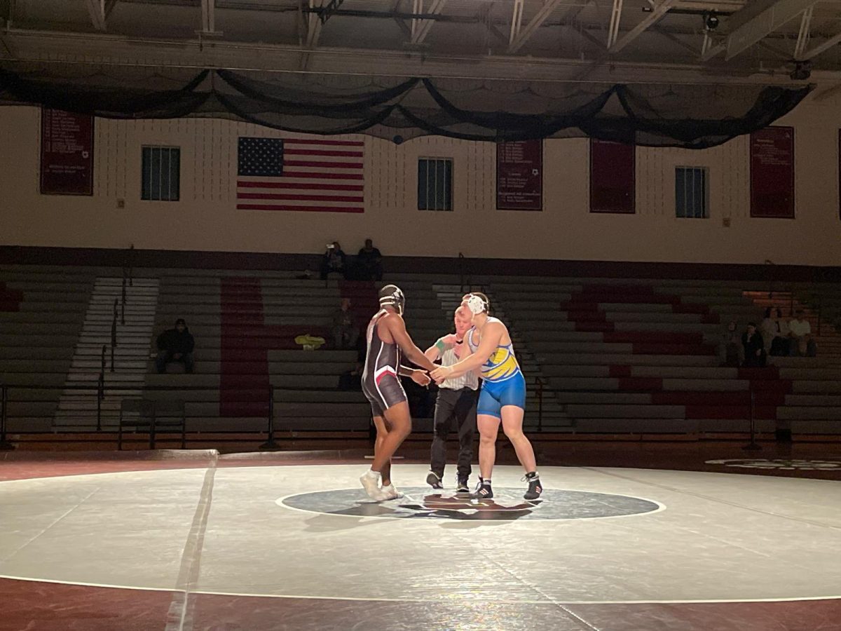 Zion Essington, '26, shaking hands with his opponent from William Allen High School after their match.