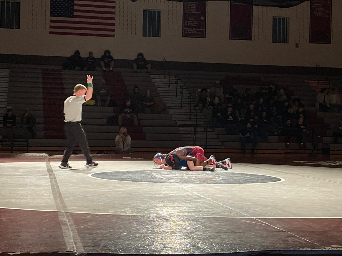 Arianna Thomas, '27, pinning her opponent and getting 3 points for her takedown.
