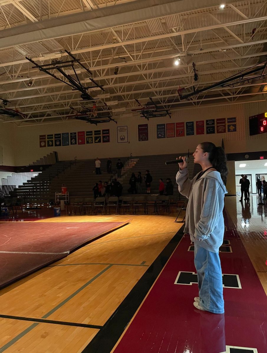 Blank singing the national anthem.