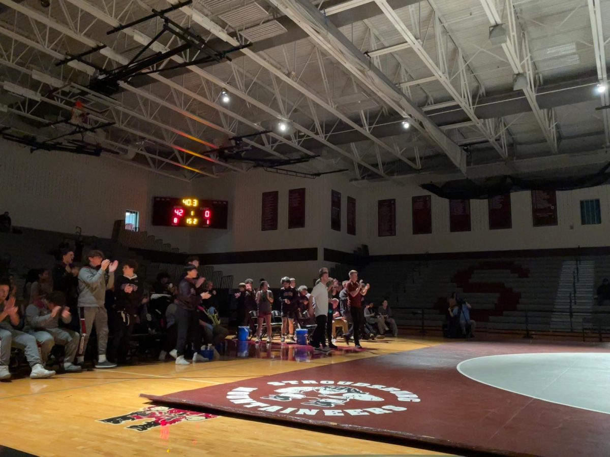 SHS Wrestling teams cheering on their peers during their matches.