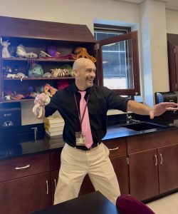 Mr. Zimmerman throws stuffed animals too his class.