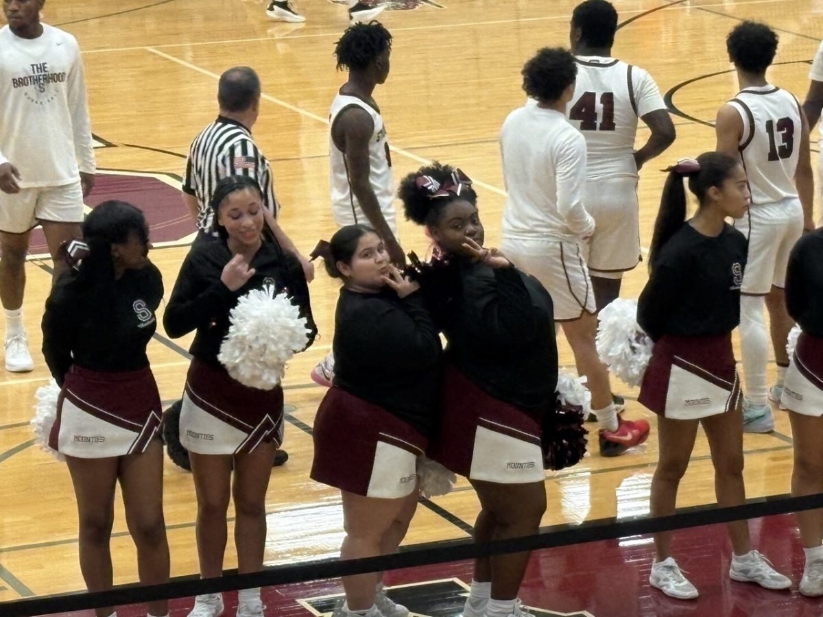 Cheerleaders pose for a picture.  