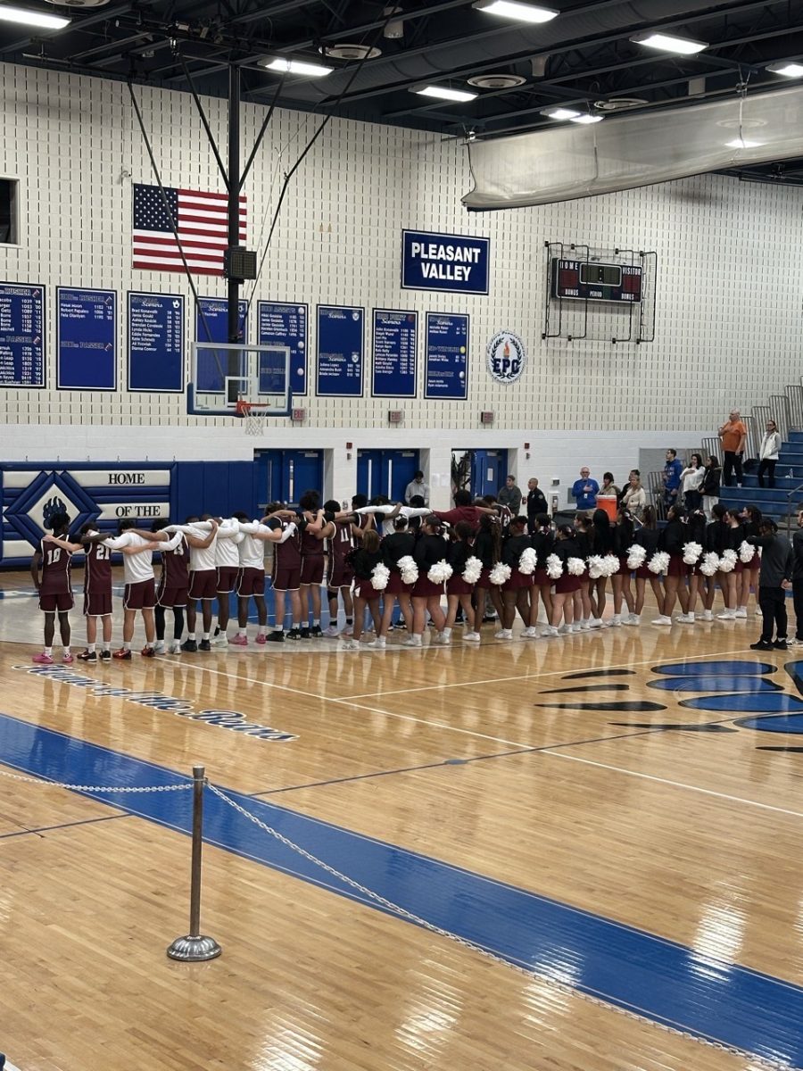 SHS Cheerleaders and basketball team pledge to the flag before the game.