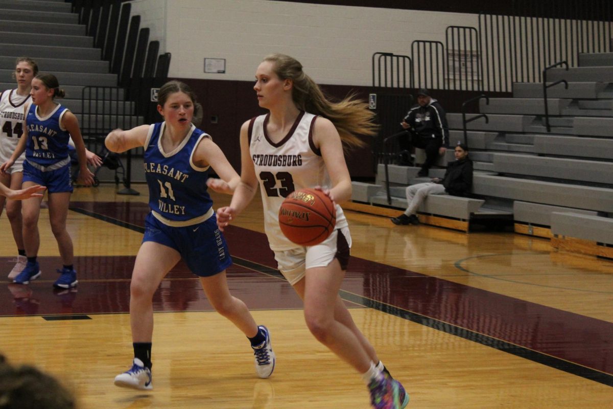 Mckayla Strunk, '25, dribbles the ball in a game against Pleasant Valley.