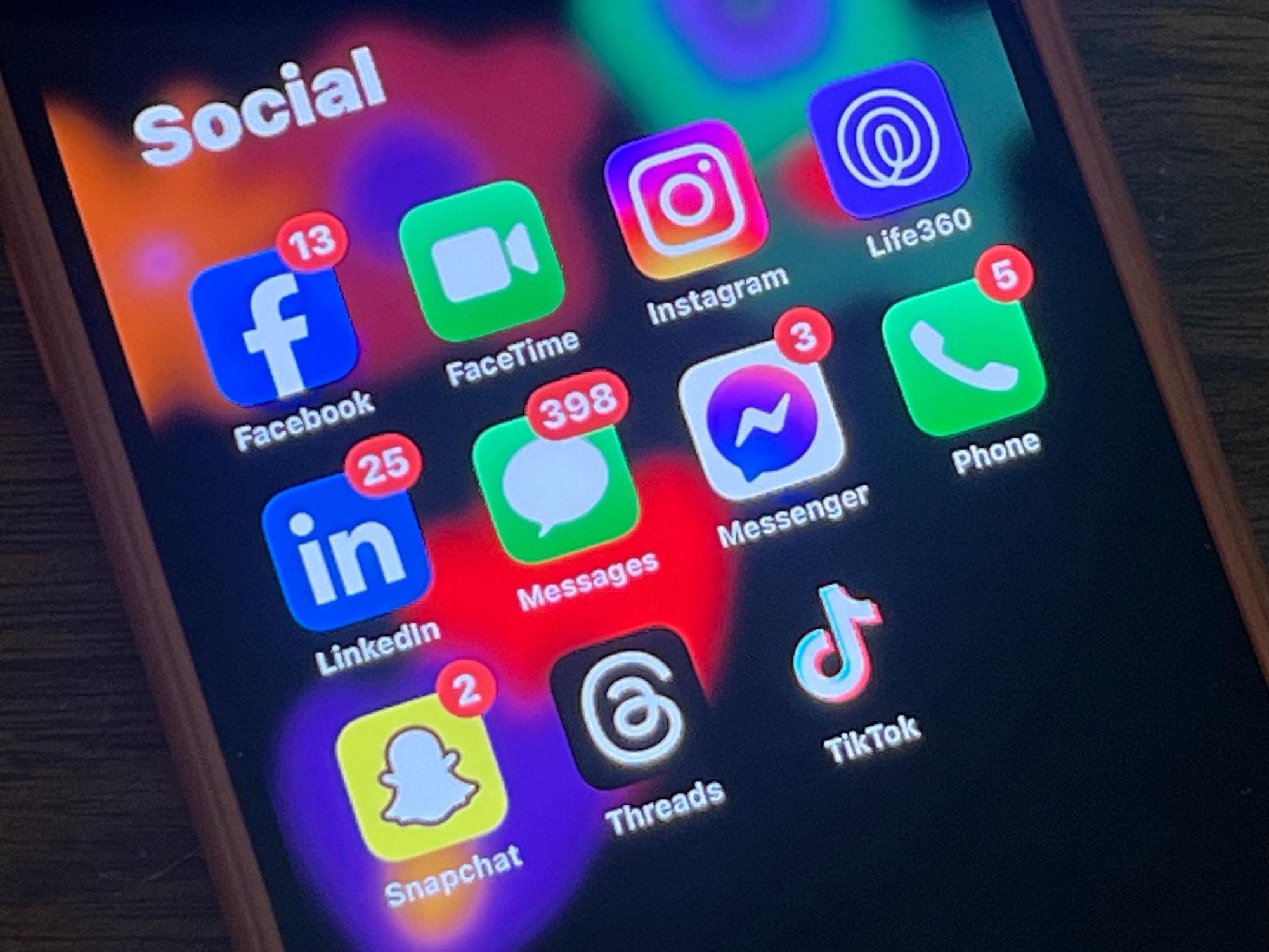 Most cell phones are equipped to handle downloading multiple social media apps. A photo with common social media platforms on an iPhone.