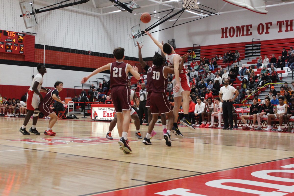 Center Marvin Dorvilus, '25, getting a defensive stop against Pocono Mountain East.