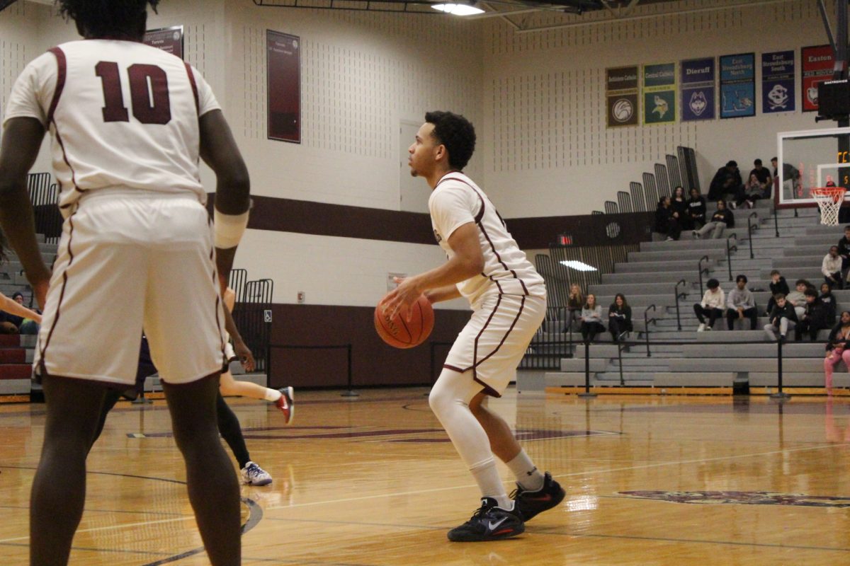 SHS guard and forward, Deon Davis, '26 attempts a three point shot against East Stroudsburg South.