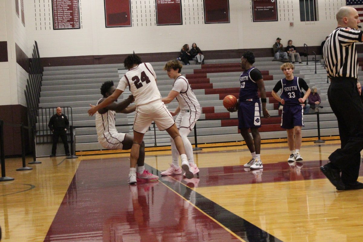 Marquise Long, '26, and Nate English, '28, help up Kam Knight, '26, after he was fouled.