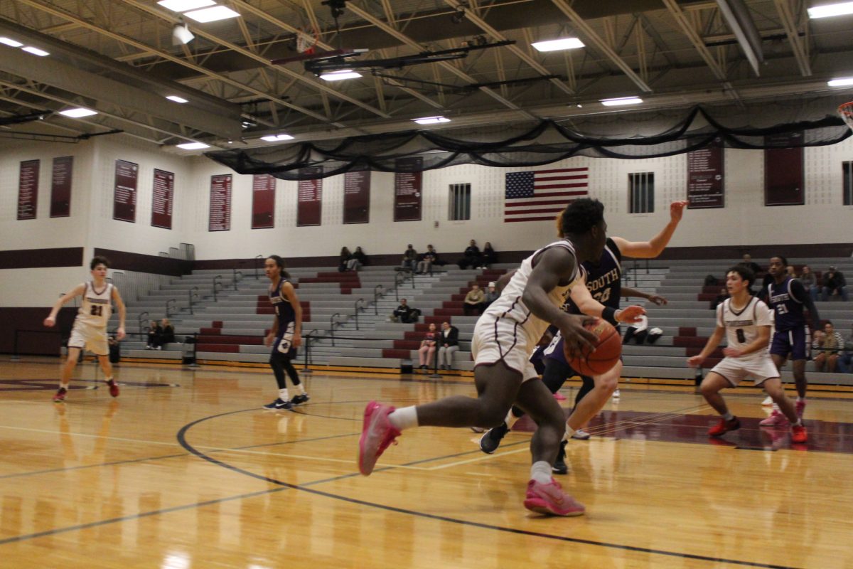 Kameron Knight, '26, driving into the paint