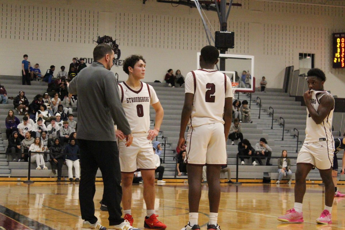 The boys speak with coach Tarik El-Bassiouni.