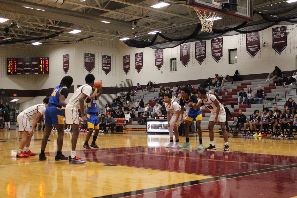 Marvin Dorvilus, '25, and Nazir Williams, '26, boxing out their defenders