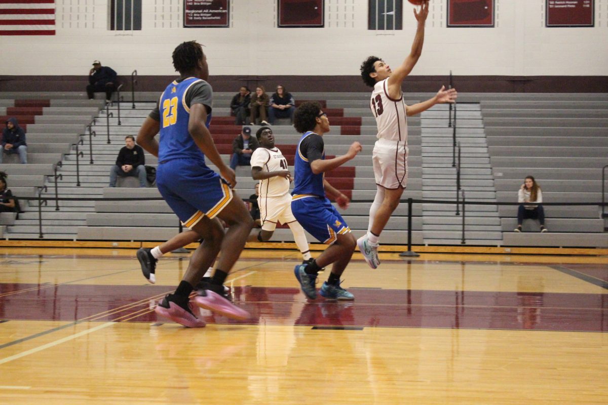 Essam Alrefai, '26, making a layup.