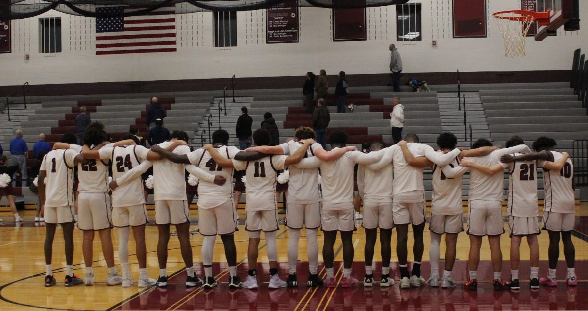 SHS varsity boys' basketball team pay their respects during the National Anthem on the Pocono Mountain West home court. 