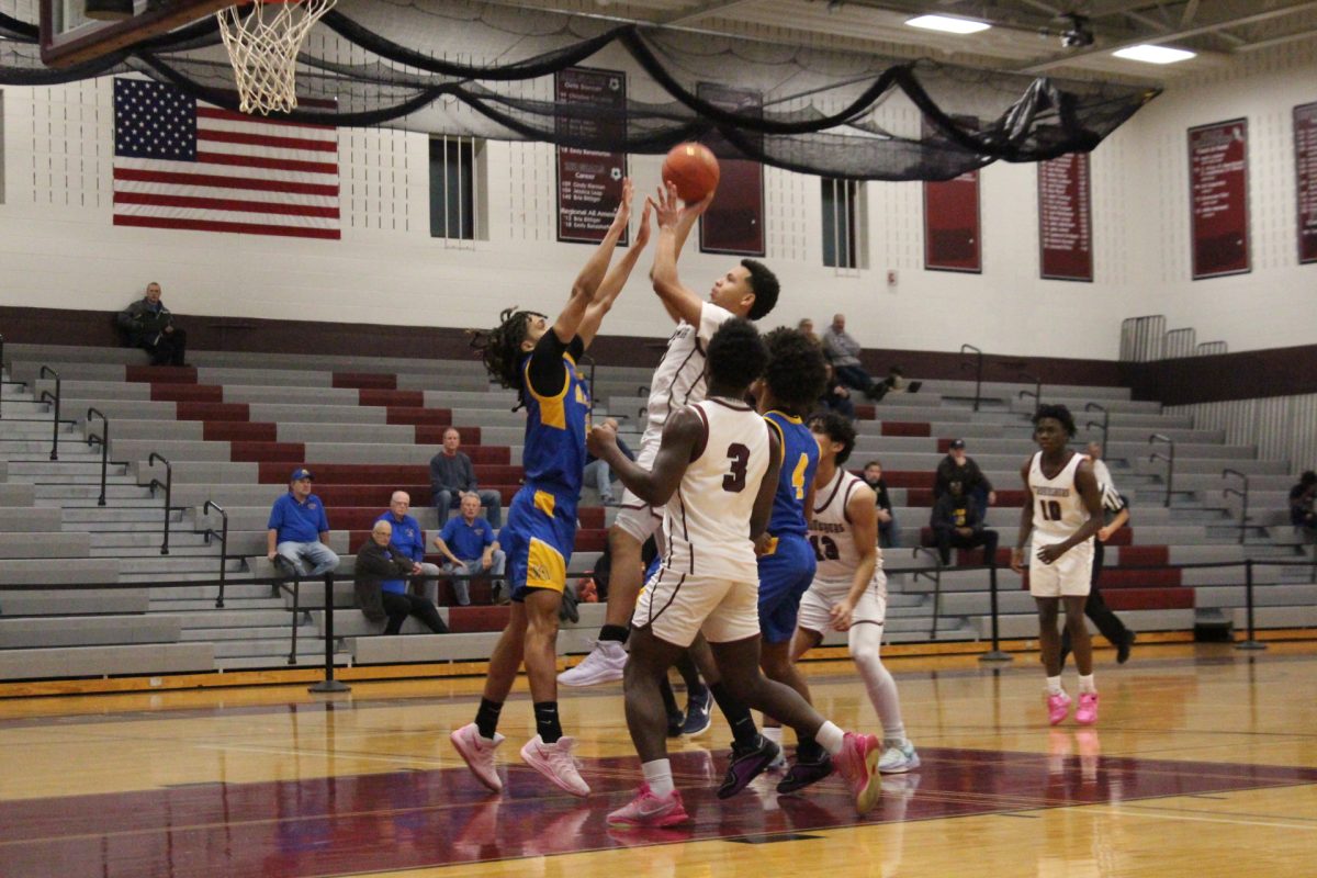 Deon Davis, '26, making a move at the basket