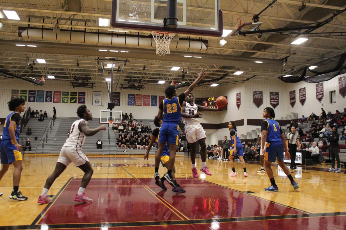 Michael Gilmore, '27, making a layup.