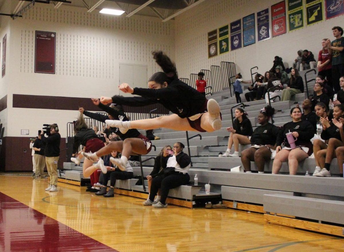 The cheerleaders demonstrate flexibility as they celebrate a basket scored against East Stroudsburg North. 