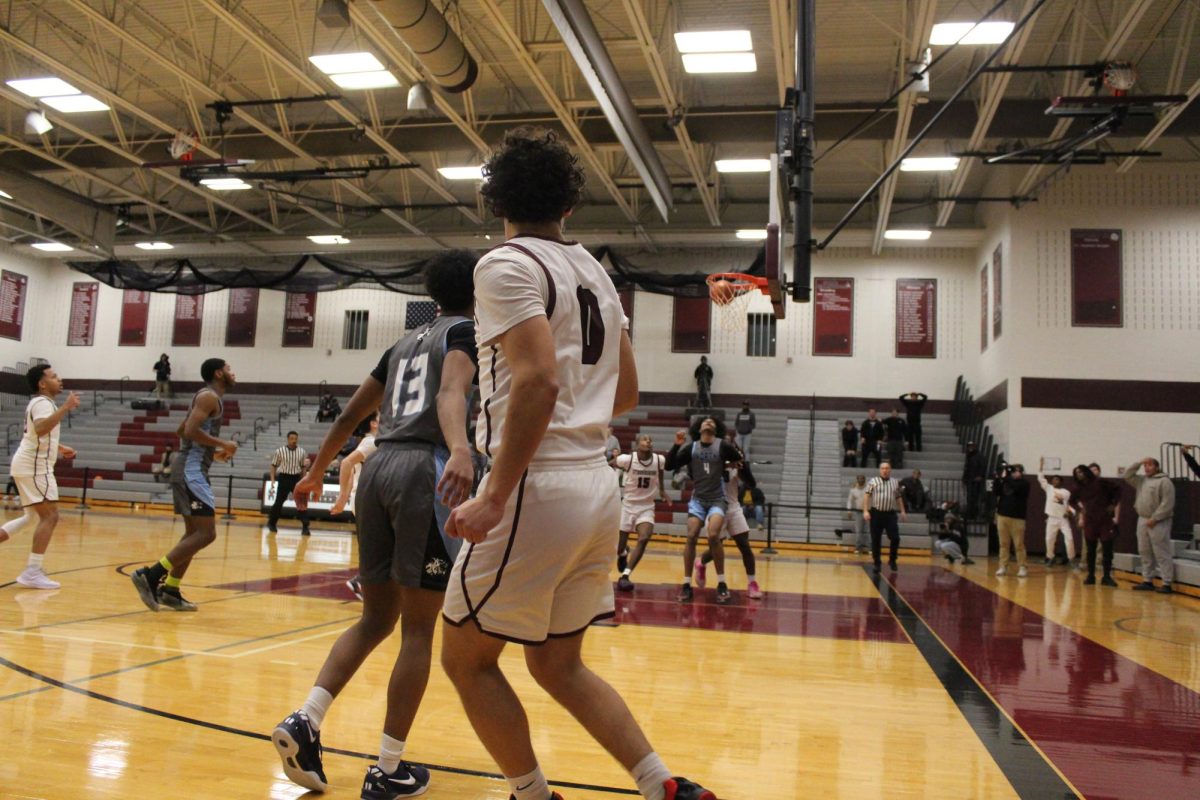 Alex Paciti, '25, getting back on defense after making a three pointer.