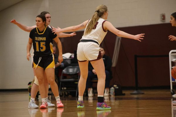 Mckayla Strunk, '25, defending against Freedom High School's girls basketball team.