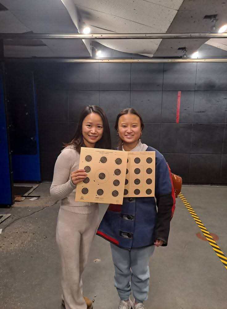 Sophia Lin, '26, with her parent holding both of their scores.