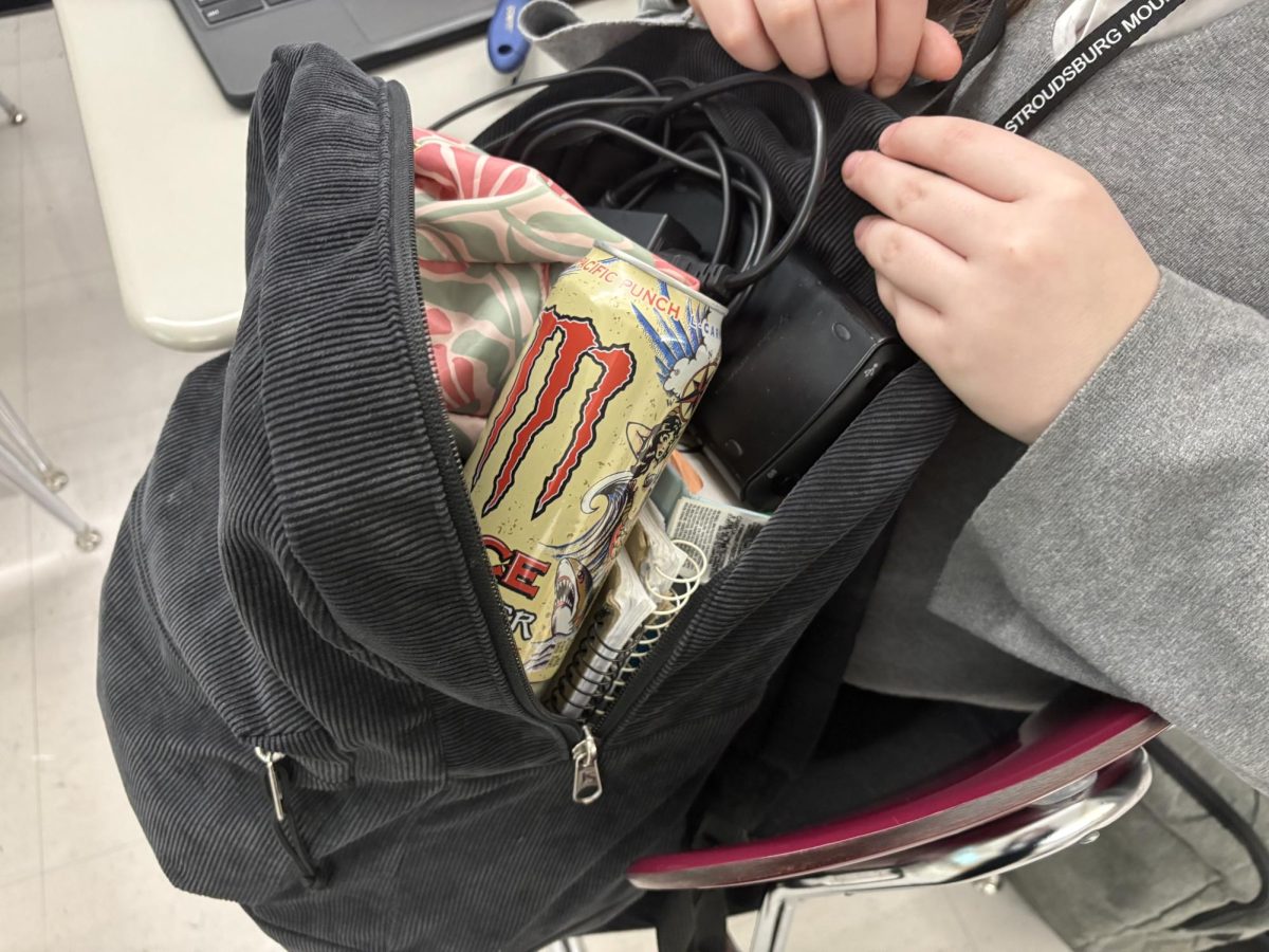 Stroudsburg High School student opening her bookbag to find an energy drink.