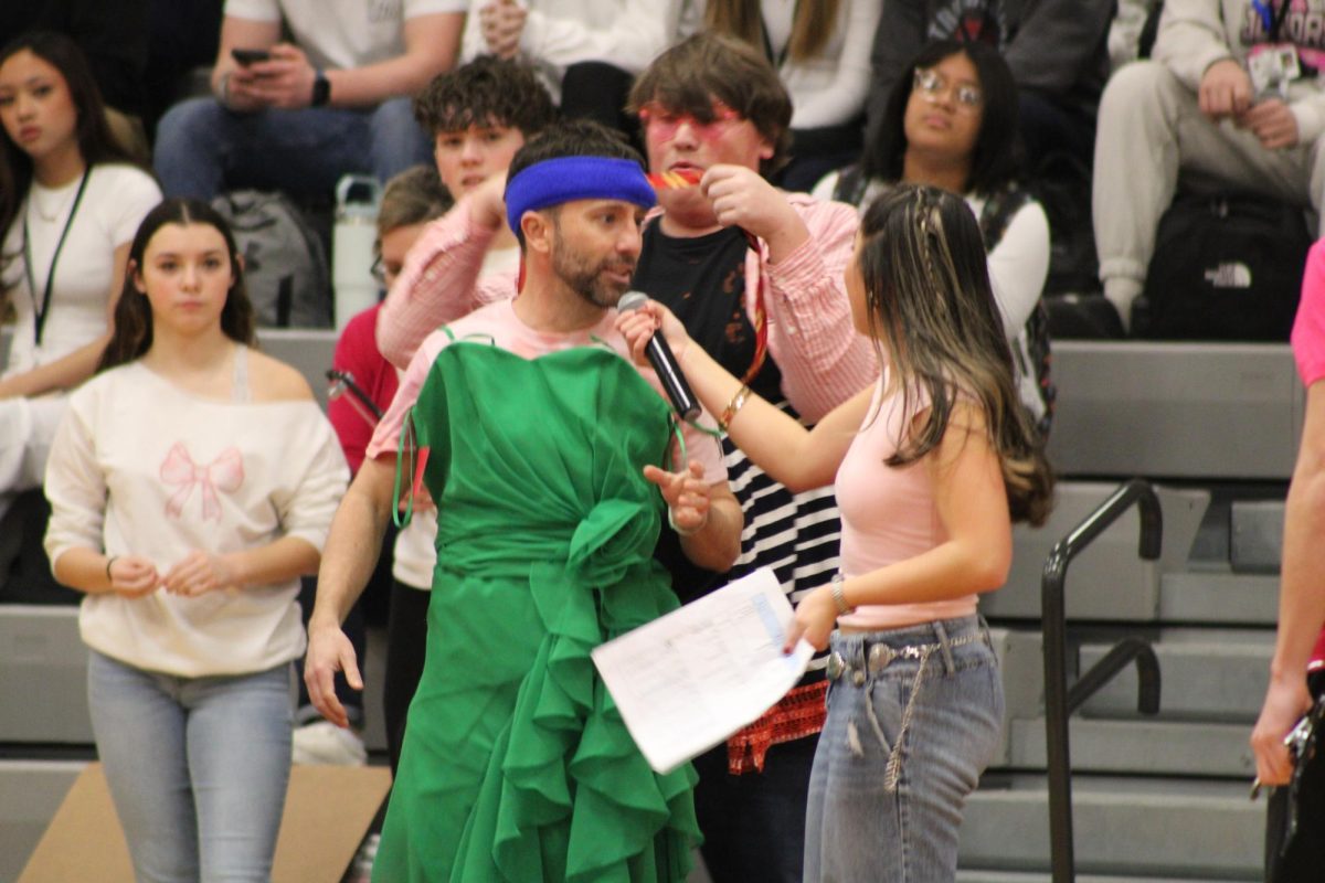 Mr. Hakim slaying a green dress, after being dressed by King Colton Leeth, '25