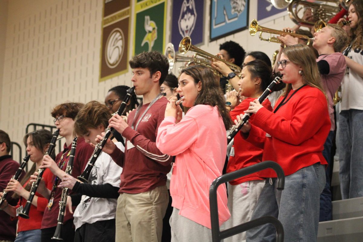 The clarinet section of the marching band playing during musical chairs.