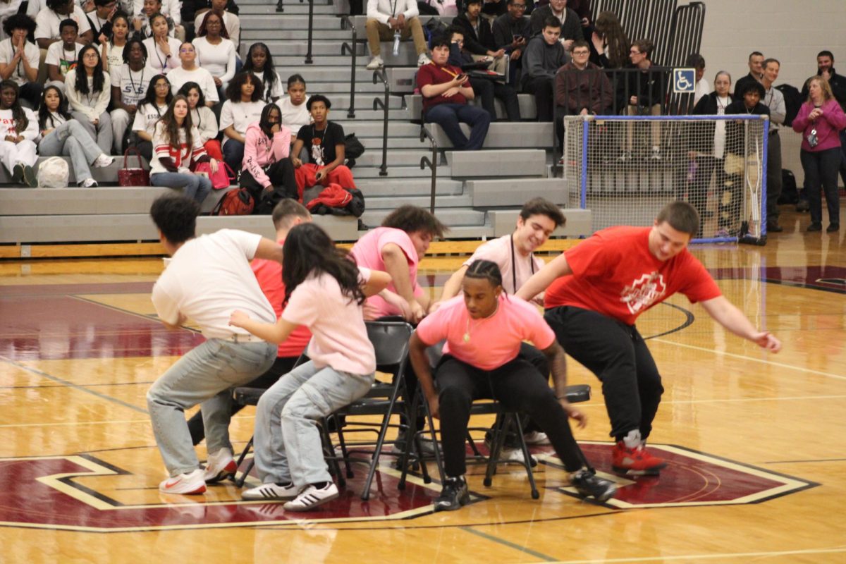 The participants of musical chairs sitting down after the music stops.