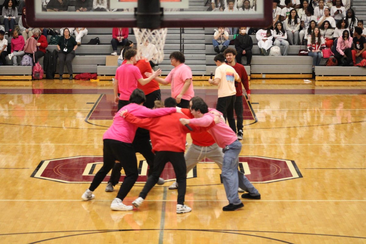 The basketball teams getting ready to play while huddling.