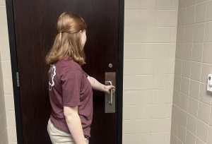 Crista Kopec, '26, trying to open the C Hallway bathroom on the first floor with no luck.