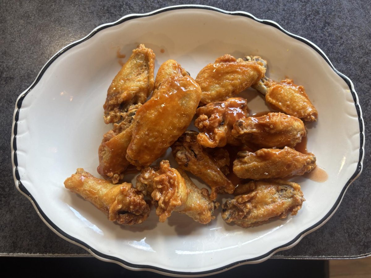 A plate of chicken wings, which are a popular food to eat during the Super Bowl.