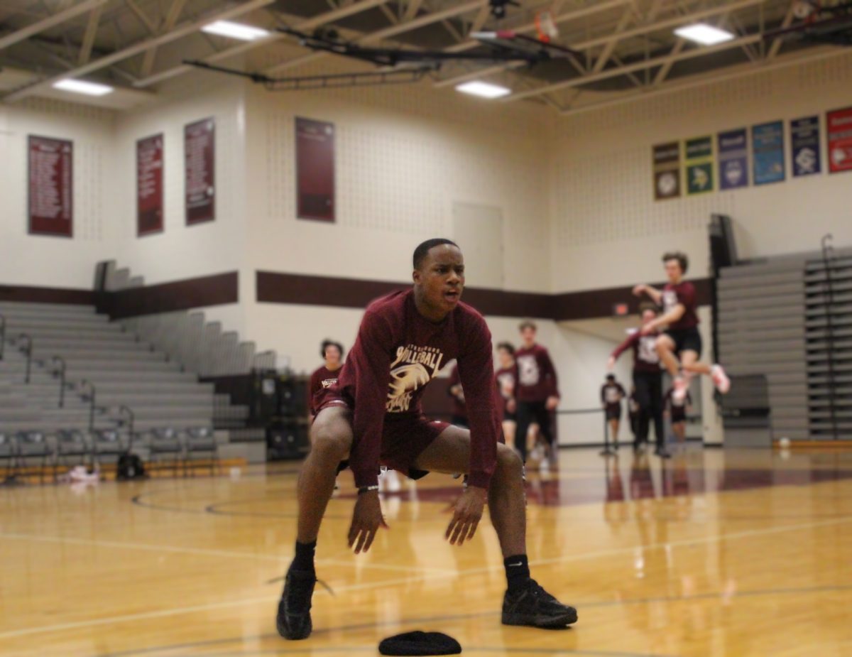 Josh Ivers-Green, '27, hypes the crowd before the game.