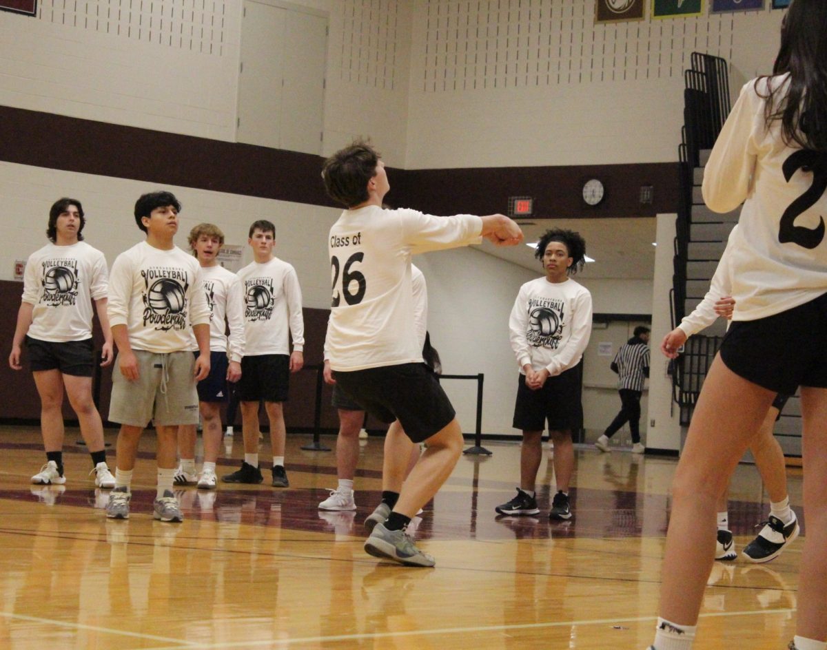 Alvino Trifilo, '26, bumps the ball over the net.