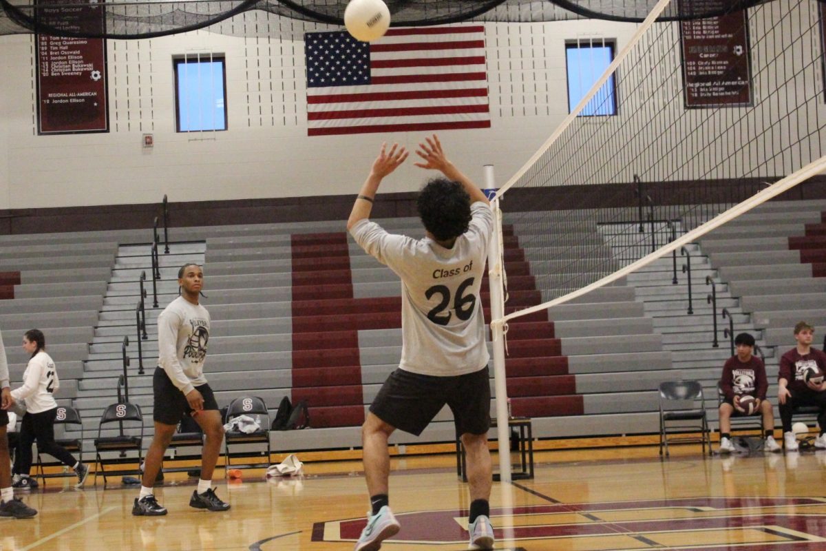 Essam Alrefai, '26, prepares to set the ball.