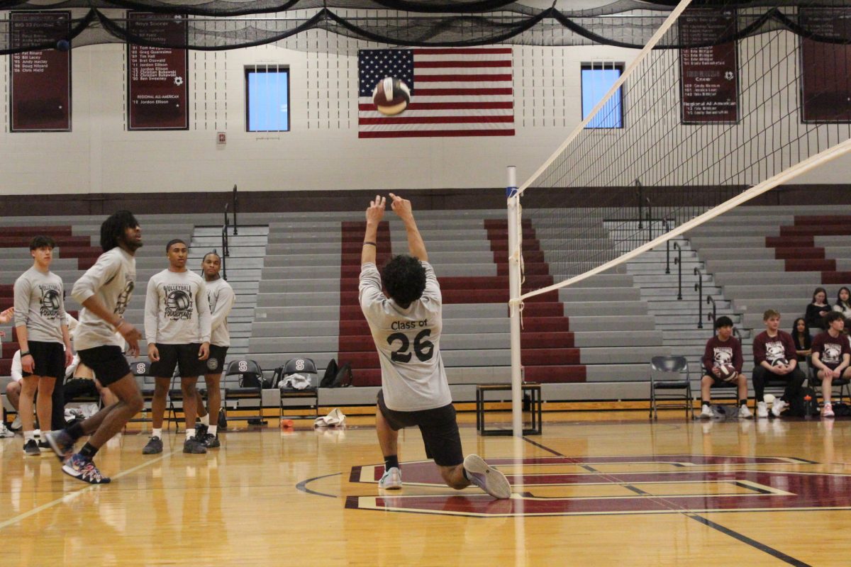 Essam Alrefai, '26, sets the ball to his teammate before the game.