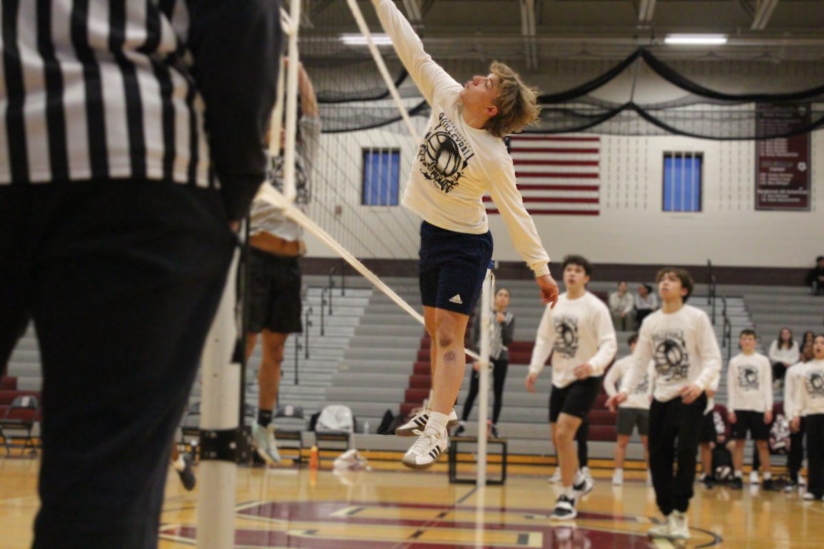 Kaiden Schatzman, '26, spikes the ball over the net.